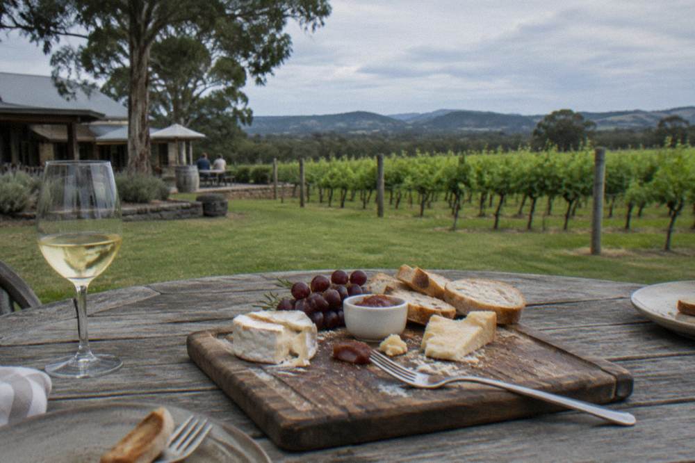 A grazing platter of cheese and bread on a winery table