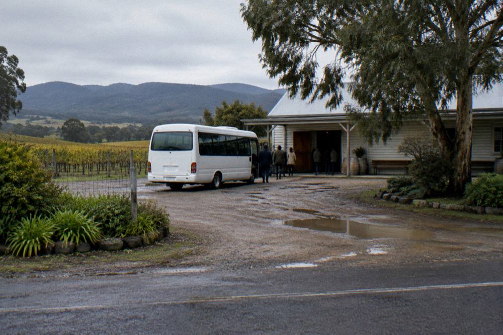 A small bus parked outside a Hunter Valley cellar door at midday