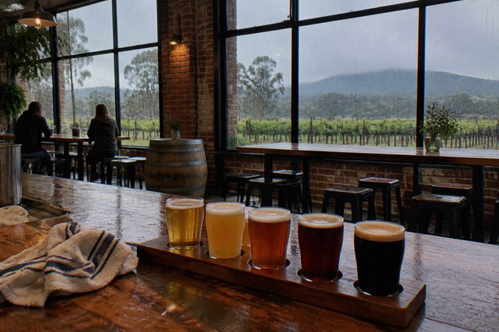 Tasting flight of craft beers on a timber bar top